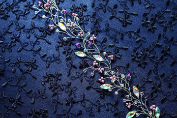 Sprig for the hair. Barrette. Decoration for the bride. Textured background and handmade jewelry closeup.