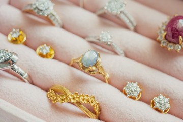 Gold and silver diamond gemstone ring and earrings in luxury jewelry box