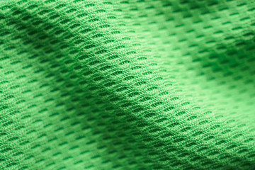 Green fabric sport clothing football jersey with air mesh texture background