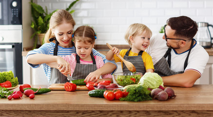 appy family with child  preparing vegetable salad