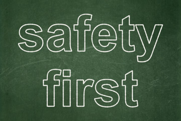Privacy concept: text Safety First on Green chalkboard background