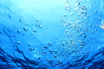 Underwater bubbles in blue water   