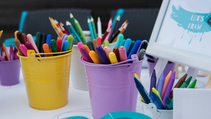 .children's drawing school, children's creativity with brushes and felt-tip pens close-up.