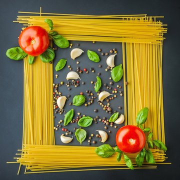 uncooked pasta, tomto an spieces as picture background