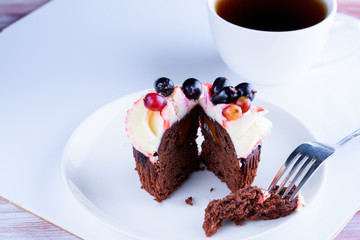 A cup of fragrant tea with delicious cake in white dish