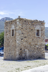 Vertical wide shot of old masonry building under clear sky