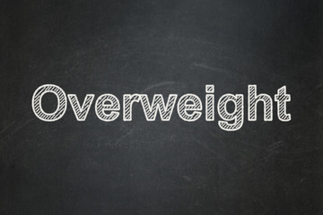 Healthcare concept: text Overweight on Black chalkboard background