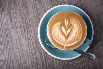 latte or Cappuccino with frothy foam, coffee cup top view on table in cafe.