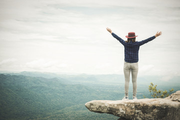 young woman with the success in the highest point - success concept