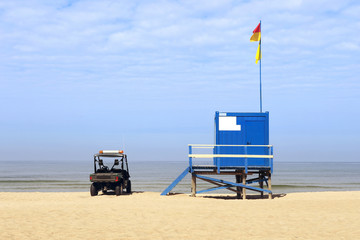Lifeguard tower and car on the beach. Lifeguard cabin on Baltic sea beach in Lithuania.