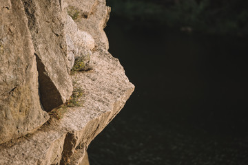 selective focus of rocky cliff over river