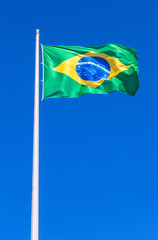 Flag of Brazil flying in the wind against the sky