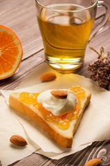 green tea with bread, nuts, jam and yogut