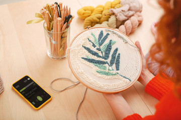 Inventive housewife. Inventive enthusiastic housewife feeling creative while embroidering nice...