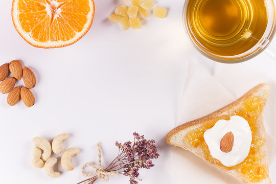 green tea with bread, nuts, jam and yogut