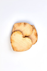 Wooden plywood hearts, top view. Heart shaped cutouts from wood isolated on white background.