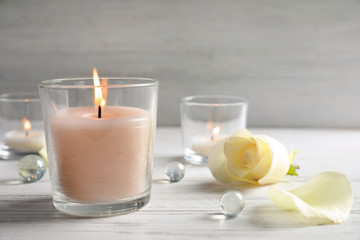 Beautiful composition with burning wax candle on table