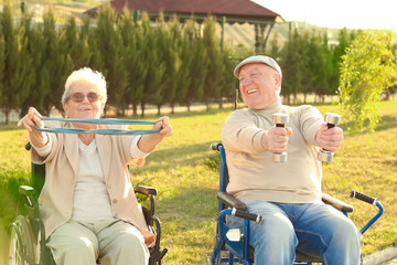 Senior man and woman from care home doing exercise outdoors