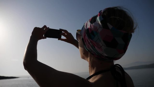 Young happy woman enjoy take selfie picture during summer sea beach leisure in Greece