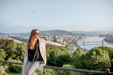 Young woman enjoying beautiful aerial cityscape view on Budapest during the morning light, Hungary