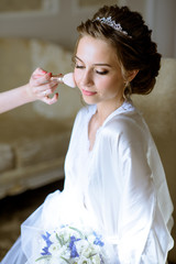 Fototapeta na wymiar Wedding makeup artist making a make up for bride