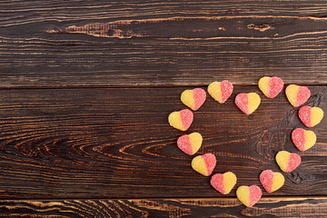 Colorful candies forming heart shape. Romantic decoration with sweets. Valentines Day greeting card.