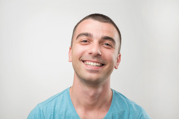 Fototapeta premium Closeup ortrait of smiling man in blue t-shirt.