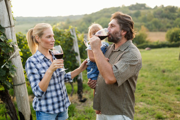 Winegrower family tasting wine