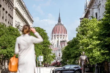 Fotobehang Woman enjoying street view with Parliament building in Budapest city, Hungary © rh2010