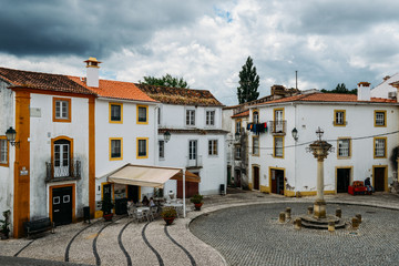 View of narrow main square consisting of limestone cozy yellow and white houses at Constancia in the Santarem District of Portugal