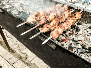 Marinated shashlik preparing on a barbecue grill over charcoal. Roasted stacked meat Shish kebab popular in Goergia. Traditional cuisine in Georgia