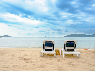 Two beach lounge chairs  on beach in vocation holidays