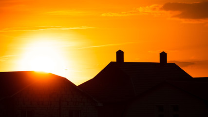 Silhouette of the roof of the house at sunset