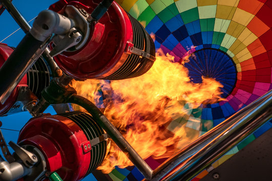 Hot air balloon, bright burning fire flame from gas burner equipment, close up from inside 