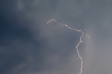 The discharge of lightning in the sky as a background