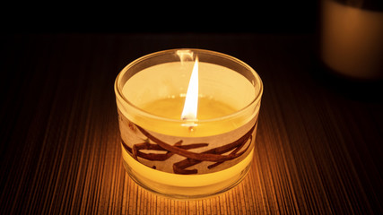 Burning scented candle in glass