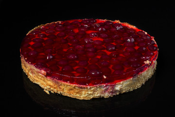 Cake cheesecake with cherry in jelly on black background © Светлана Лазаренко