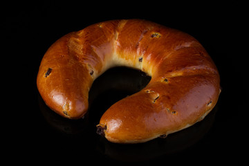 Traditional bun with yeast dough on a dark background