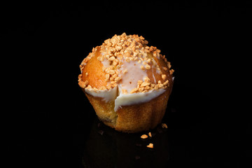 Cupcake muffin with peanuts on a dark background