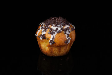 Cupcake muffin with chocolate sprinkle on a dark background