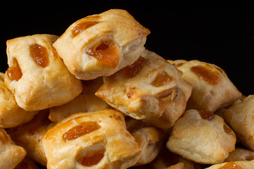 Puff pastry with jam closeup on a dark background
