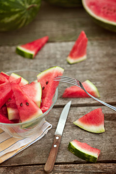 Fork on watermelon slice in glass bowl