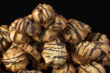 Shortbread cookie with chocolate icing on a dark background