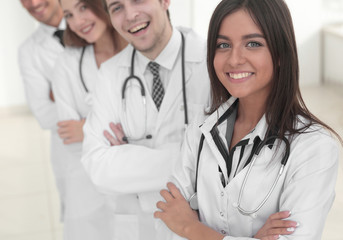 Fototapeta premium female doctor with group of happy successful colleagues