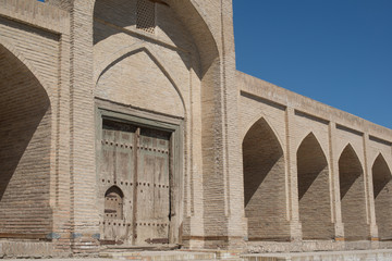 The old building, the wall with arches. Ancient buildings of medieval Asia. Bukhara, Uzbekistan
