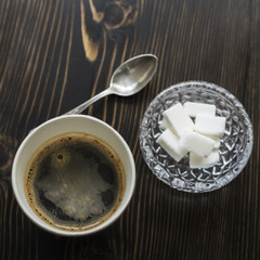 Coffee and sugar cubes on wooden table