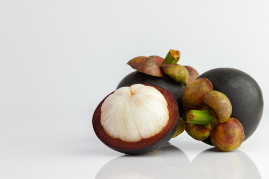 Three of the mangosteen were peeled off on a white background.