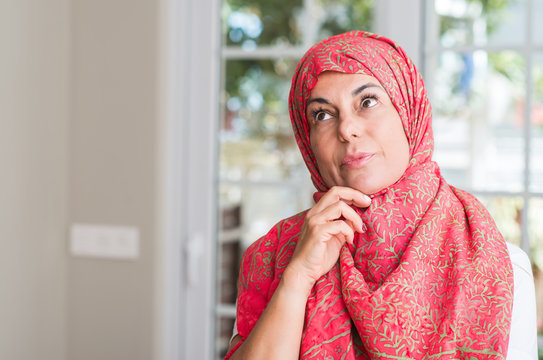 Middle aged muslim woman wearing hijab serious face thinking about question, very confused idea