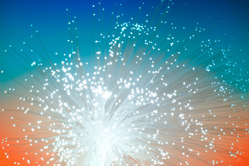Optical fiber network cable on blue-orange background, blurred technological background
