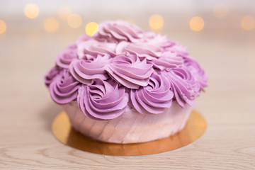 birthday concept - purple cake over wooden background